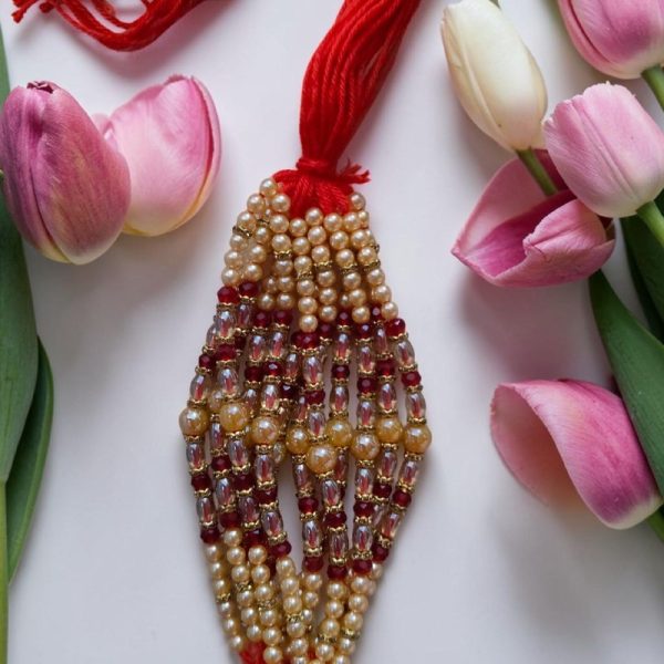 CREAM AND RED PEARL RAKHI(price per piece)